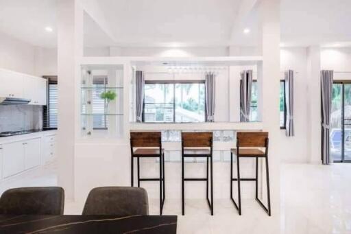 Modern kitchen with breakfast bar and high chairs