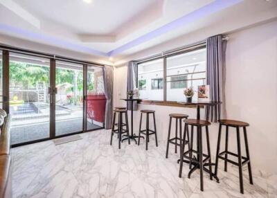 Spacious living area with bar stools and large sliding glass doors