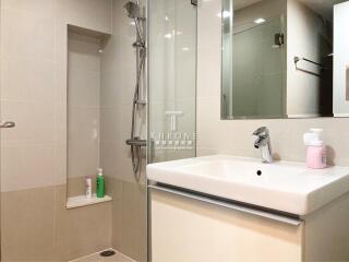 Modern bathroom with shower, sink, and mirror