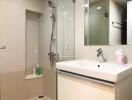 Modern bathroom with shower, sink, and mirror