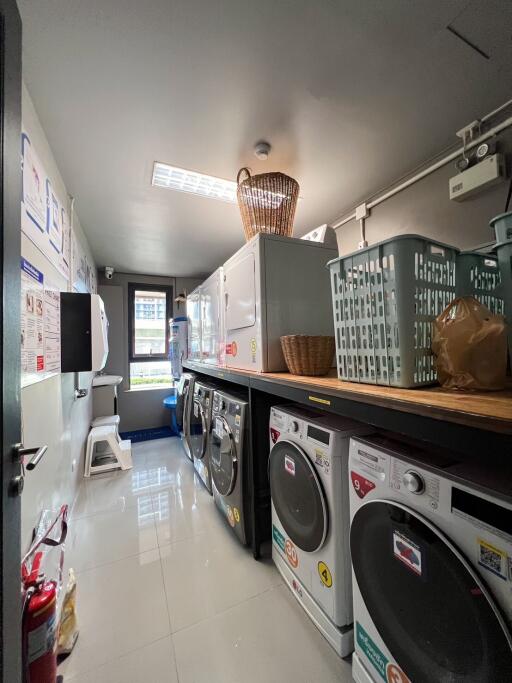 Laundry room with washing machines and dryers