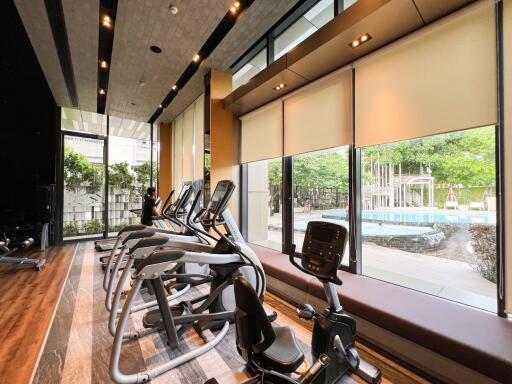 gym with exercise equipment and large windows