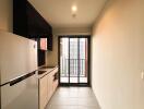 Modern kitchen with large fridge and balcony access