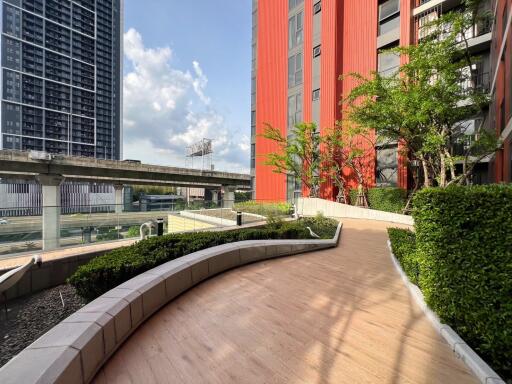 Apartment building exterior with walkway and greenery