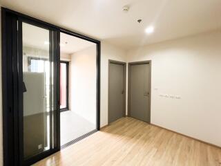 Spacious and well-lit living area with wooden flooring and modern fixtures