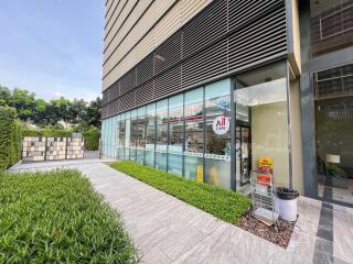 Exterior view of a commercial building with a store and walkway