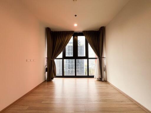 Spacious living room with large windows and wooden flooring