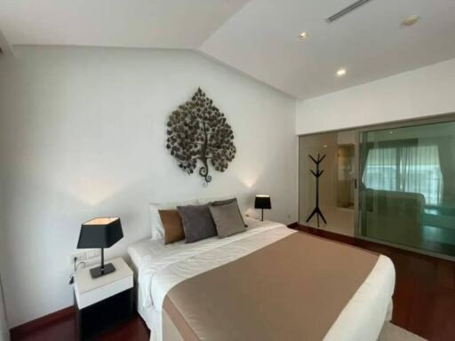 Spacious bedroom with stylish decor and modern lighting