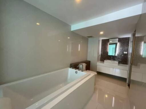 Modern bathroom with bathtub and large mirror