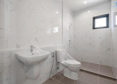 Modern bathroom with tiled floors, shower area, and fixtures