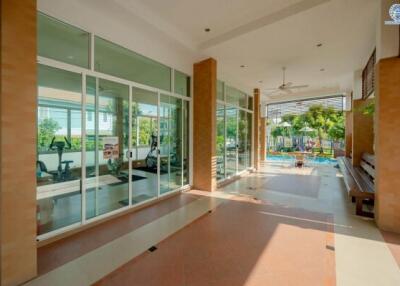 Spacious corridor with glass walls overlooking the gym and pool area