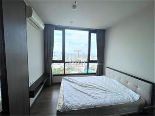 Spacious bedroom with a large window offering scenic views