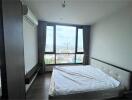 Spacious bedroom with a large window offering scenic views