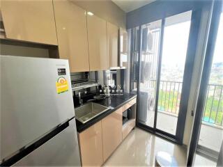 Modern kitchen with stainless steel appliances and city view