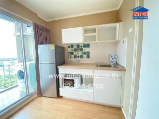 Modern compact kitchen with balcony view