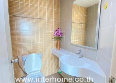 Modern bathroom with white fixtures and beige tiles