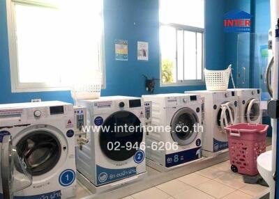 Bright laundry room with multiple washing machines