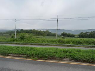 Scenic view of countryside with road and grassy fields