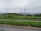 Scenic view of countryside with road and grassy fields