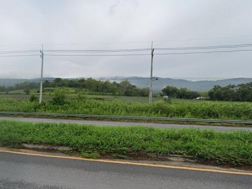 Scenic view of countryside with road and grassy fields