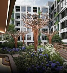 Modern apartment building courtyard with artistic tree sculptures and landscaped garden