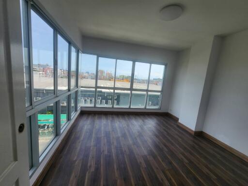 Spacious living room with large windows and city view