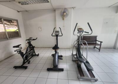 Gym with exercise equipment including stationary bikes and elliptical machine