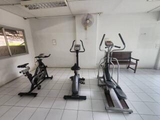 Gym with exercise equipment including stationary bikes and elliptical machine