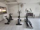 Gym with exercise equipment including stationary bikes and elliptical machine