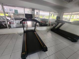 Small gym area with treadmills and large windows