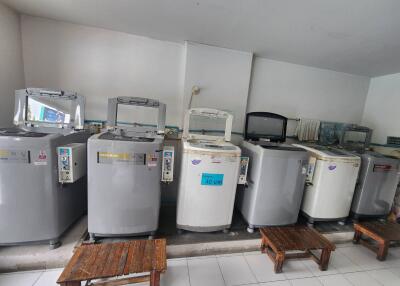 Laundry room with multiple washing machines