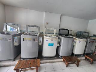 Laundry room with multiple washing machines