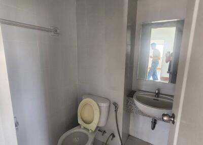 Bathroom with toilet, sink, and mirror