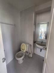Bathroom with toilet, sink, and mirror