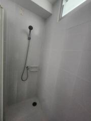 Shower with a handheld showerhead in tiled bathroom