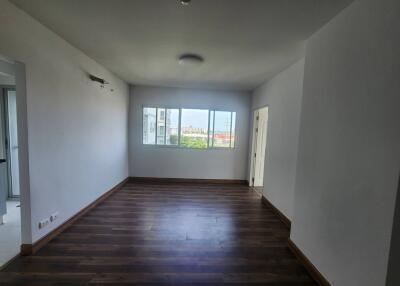 Spacious living room with wooden flooring and large window