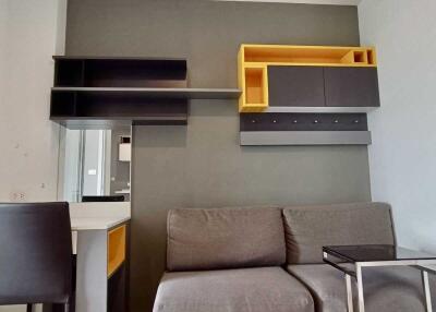 Modern living room with grey sofa and wall-mounted storage