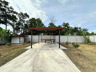 Spacious outdoor area with covered sitting space