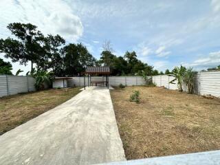 Outdoor area with covered patio and trees