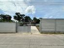 Gated entrance and driveway to property