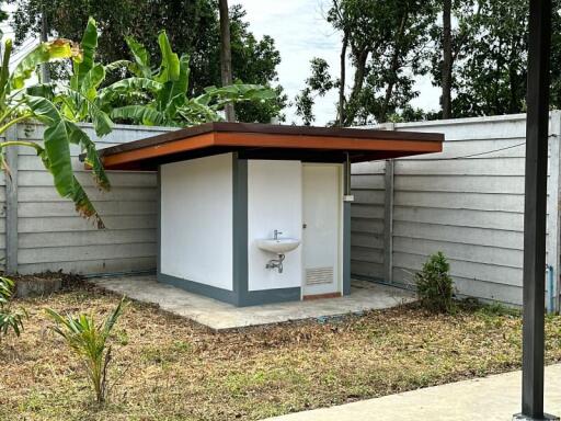 Small outbuilding with sink in backyard