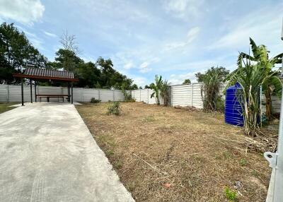 Spacious backyard view with a covered gazebo