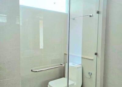 Modern bathroom with glass-enclosed toilet area