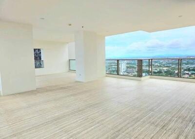 Spacious living area with large windows and city view