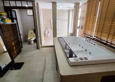 Spacious bathroom with jacuzzi and large windows