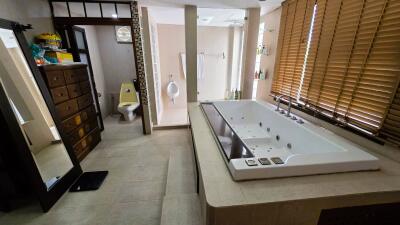 Spacious bathroom with jacuzzi and large windows