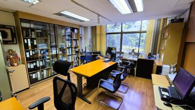 Modern office with desks, chairs, and large windows