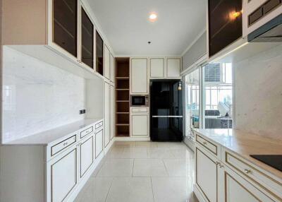 Modern kitchen with white cabinetry, black appliances, and ample countertop space