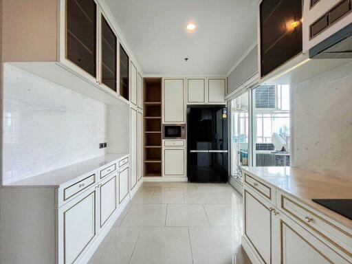 Modern kitchen with white cabinetry, black appliances, and ample countertop space