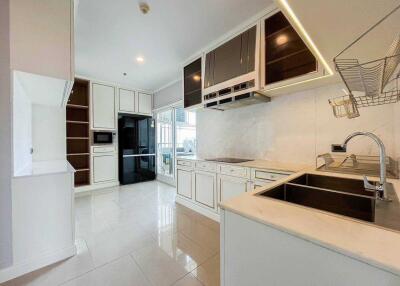 Modern kitchen with white cabinets and built-in appliances